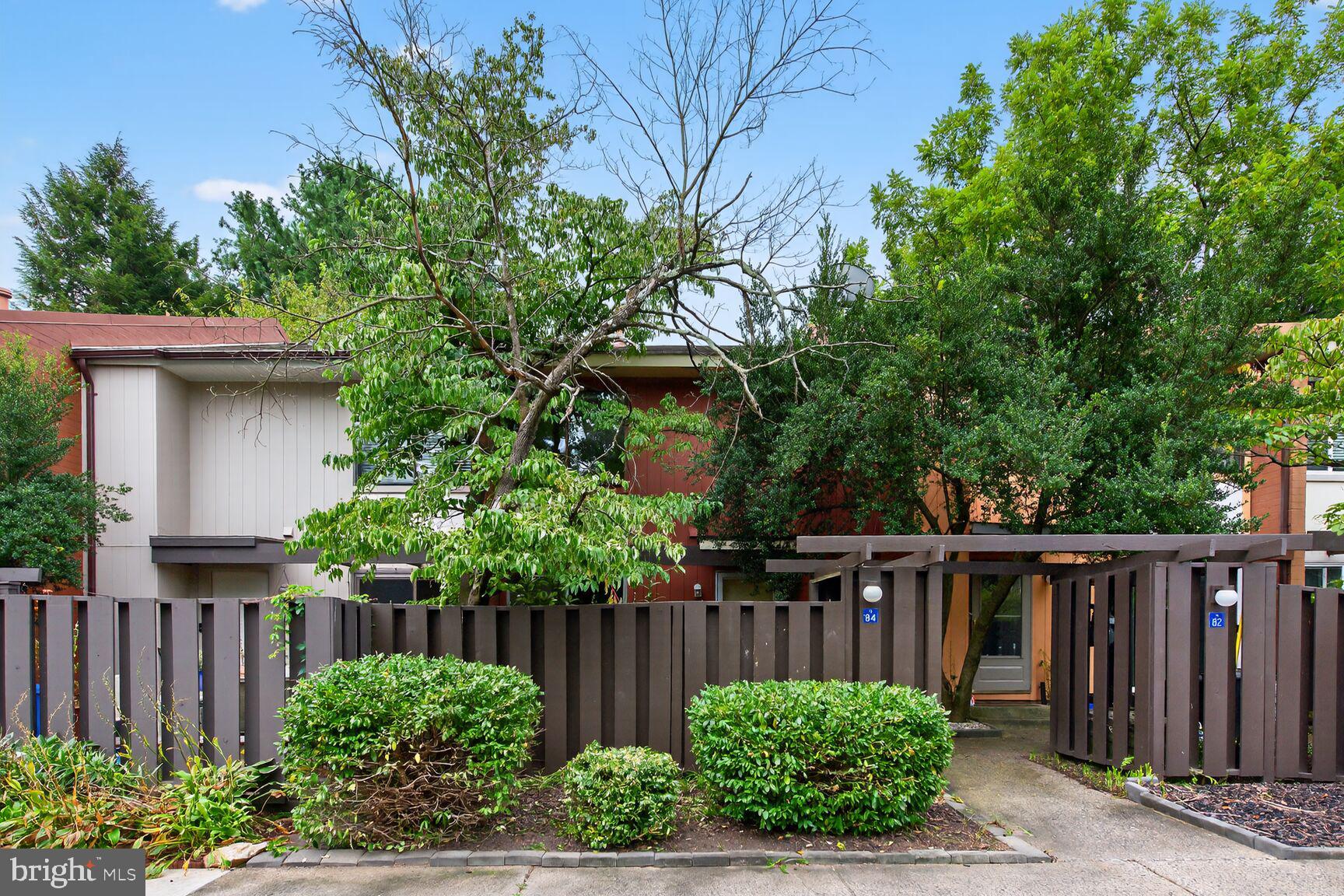 1384 Northgate Square Reston, VA 20190 - Photo 2 of 19 a wooden fence with trees in the background