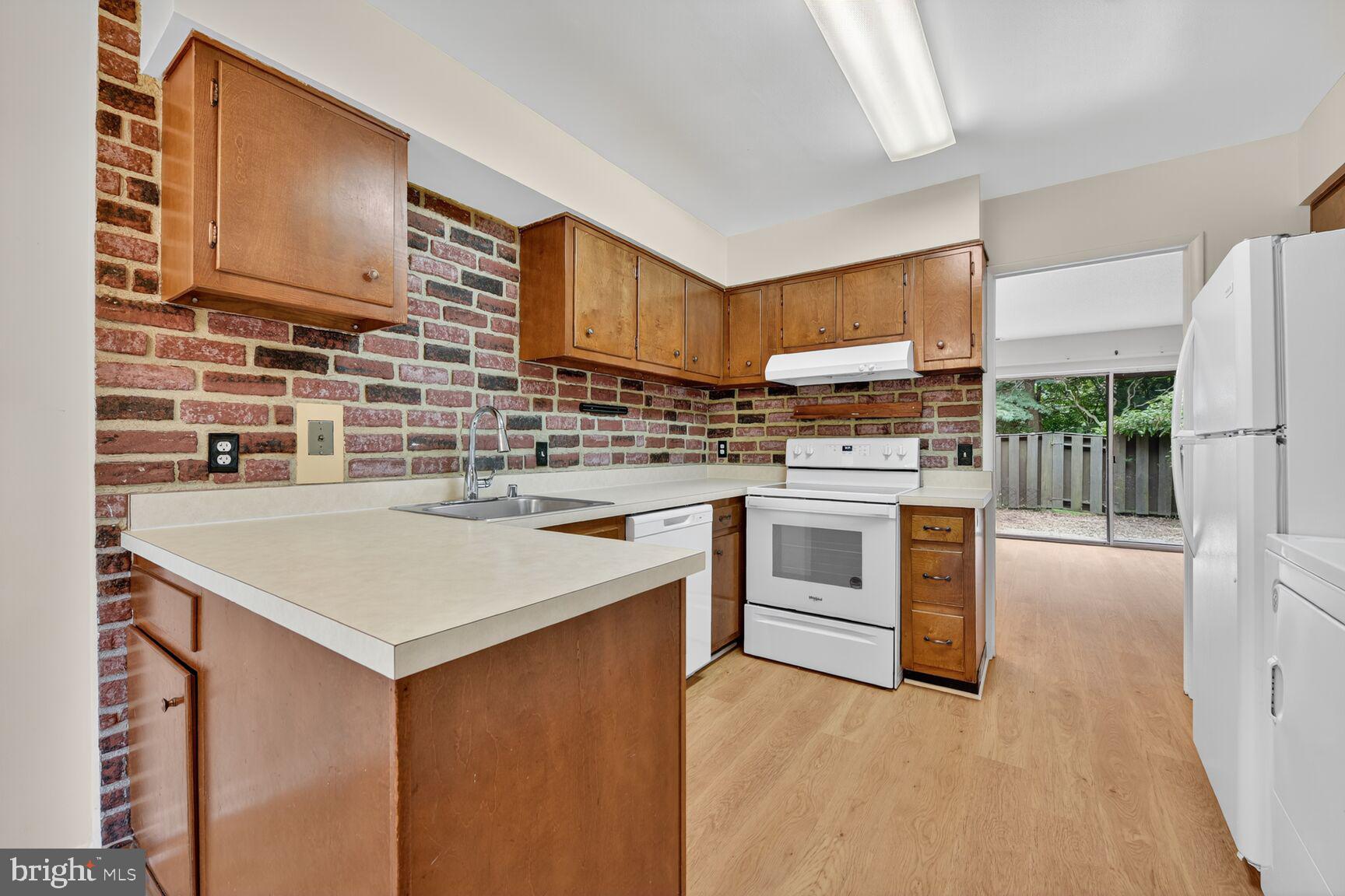 1384 Northgate Square Reston, VA 20190 - Photo 3 of 19 a kitchen with stainless steel appliances a stove a sink and a refrigerator