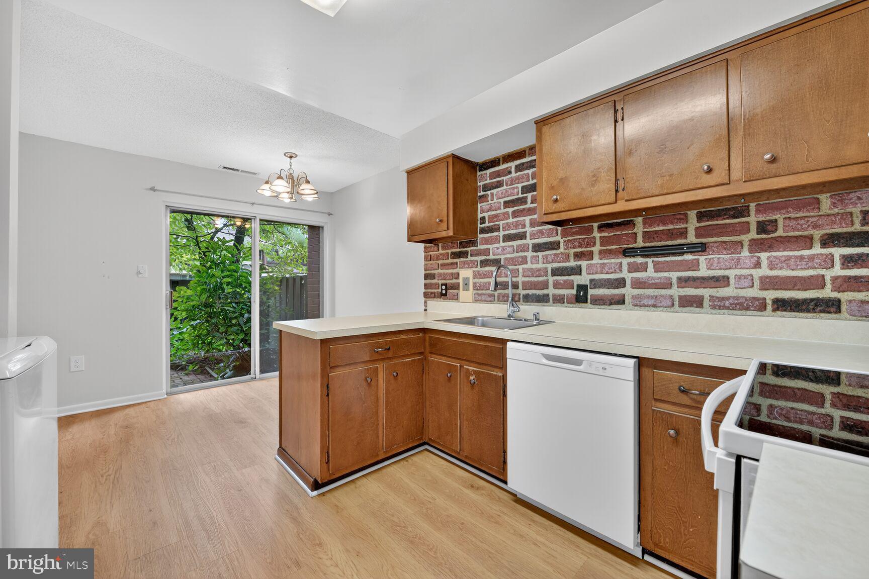 1384 Northgate Square Reston, VA 20190 - Photo 5 of 19 a kitchen with stainless steel appliances granite countertop a stove a sink and a microwave