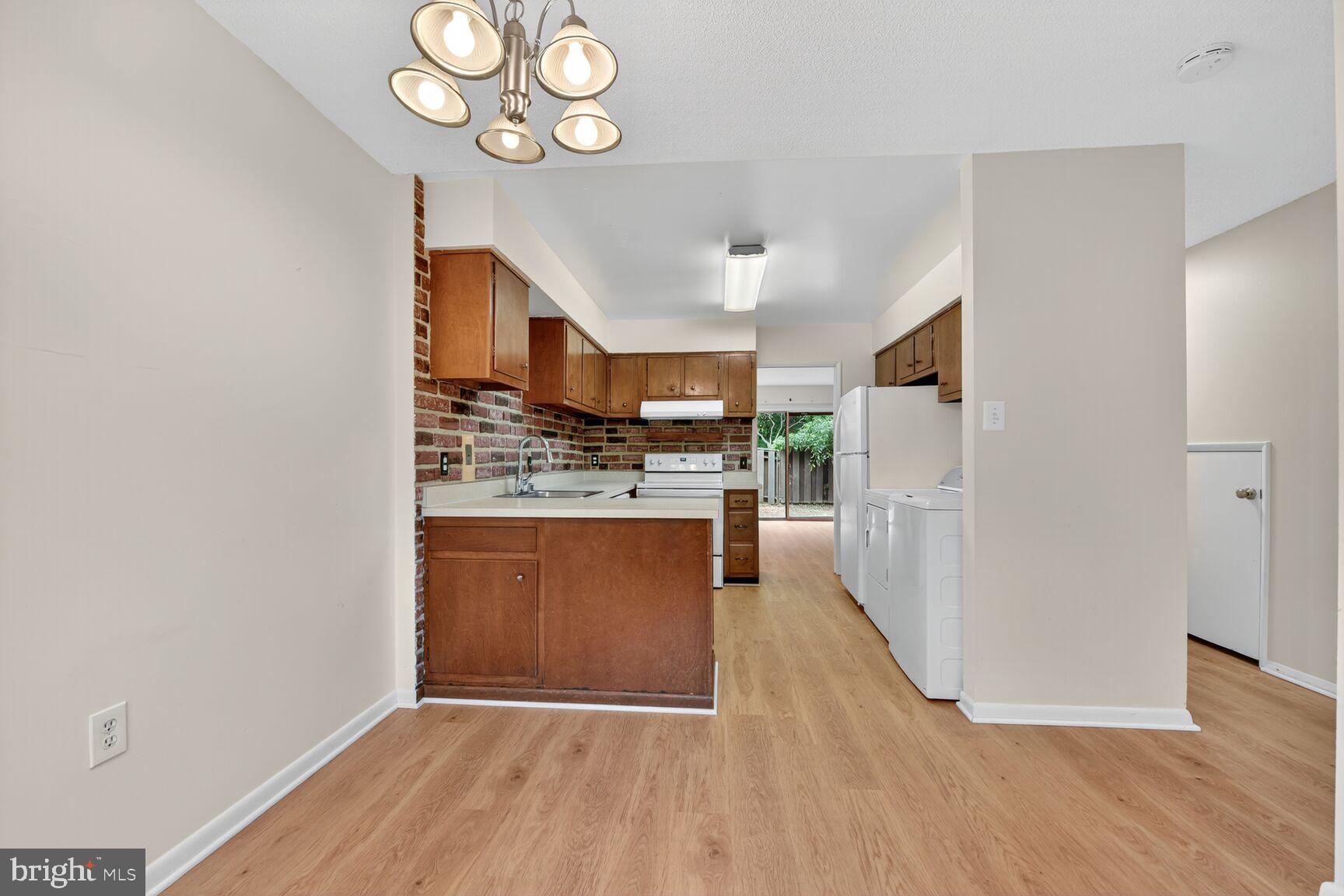 1384 Northgate Square Reston, VA 20190 - Photo 6 of 19 a view of kitchen with cabinets and wooden floor