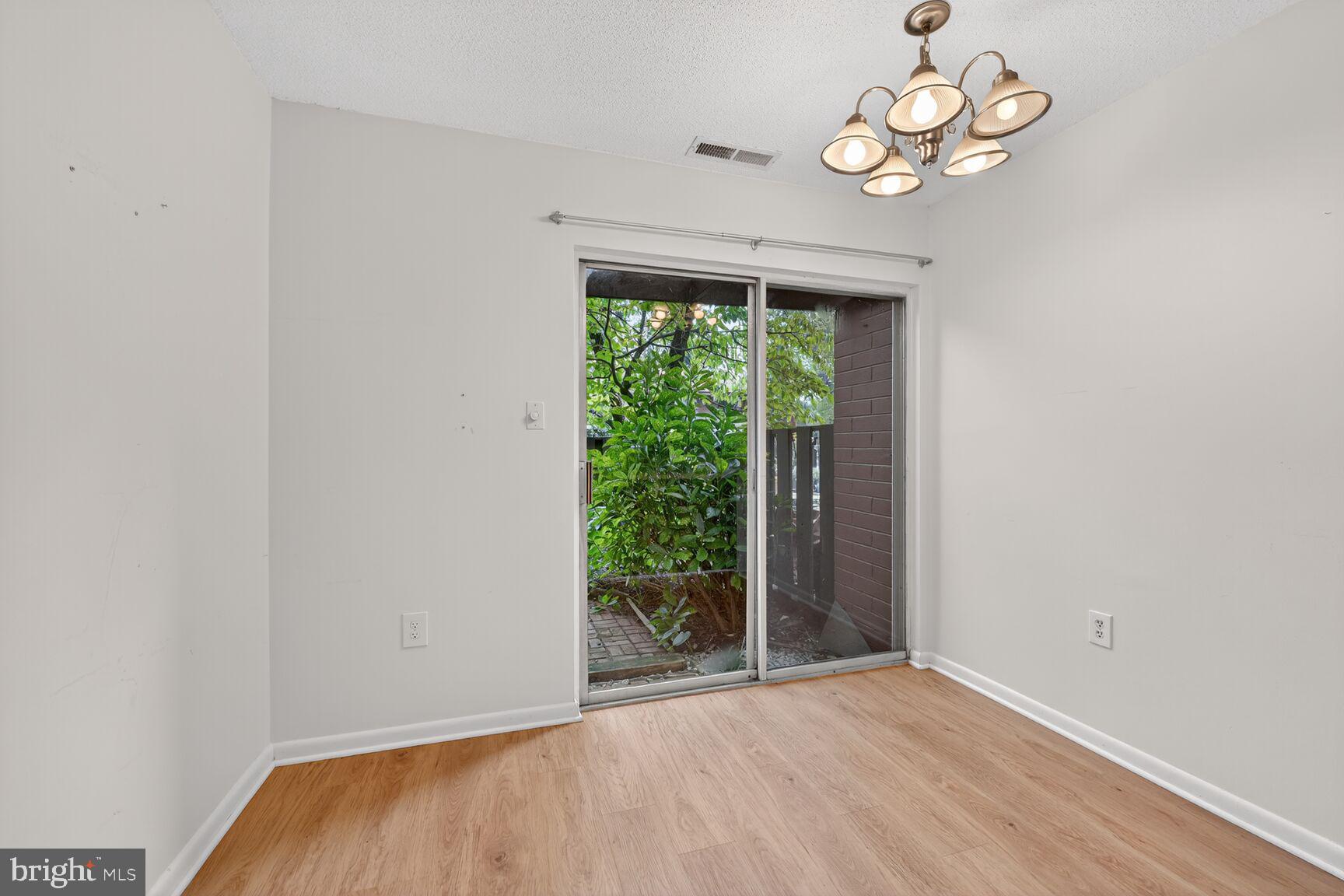 1384 Northgate Square Reston, VA 20190 - Photo 8 of 19 an empty room with wooden floor and windows