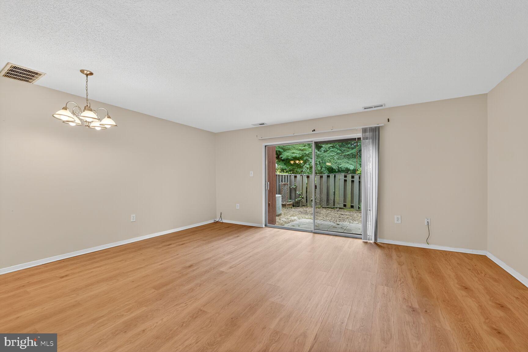 1384 Northgate Square Reston, VA 20190 - Photo 9 of 19 a view of an empty room with wooden floor and a window