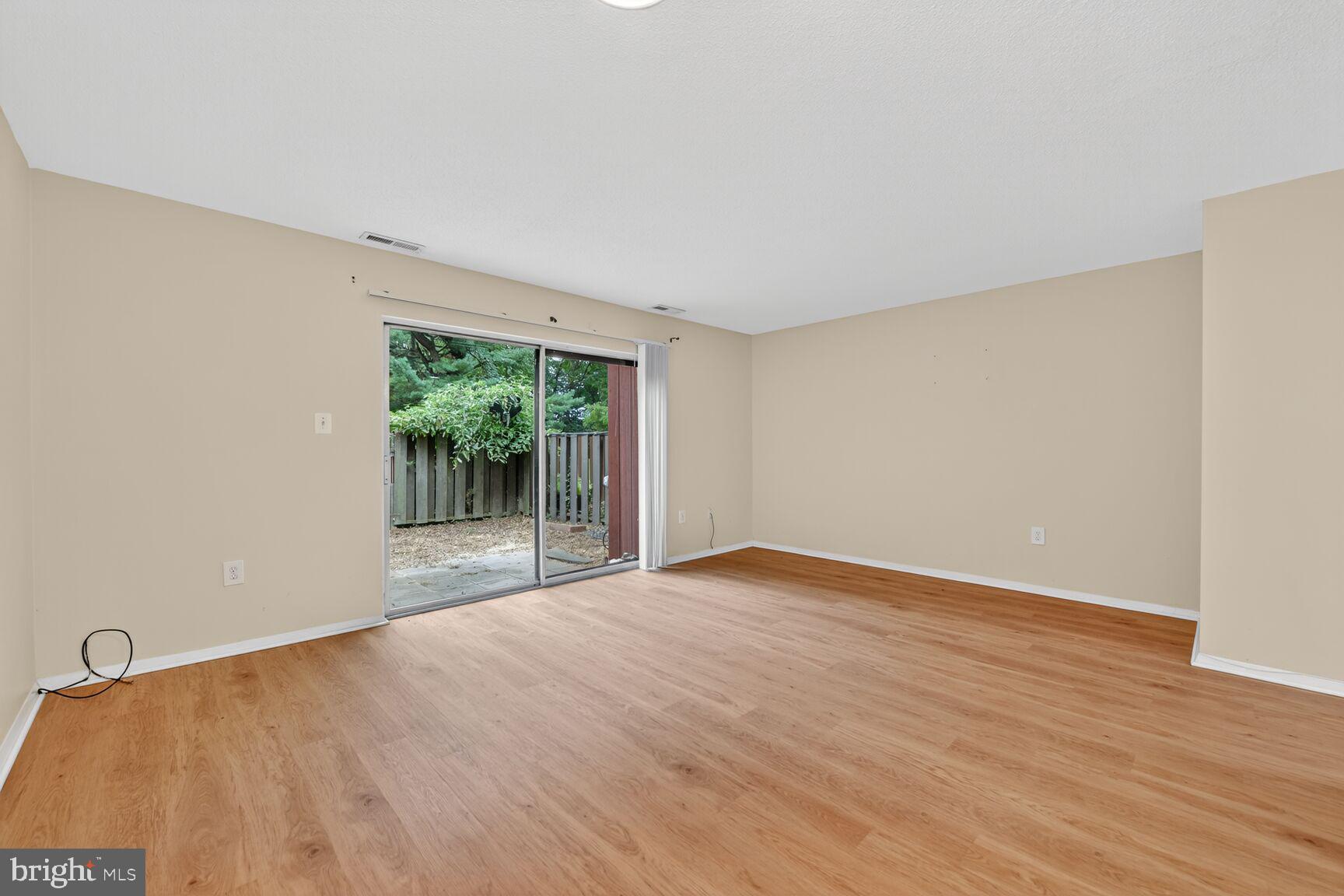 1384 Northgate Square Reston, VA 20190 - Photo 10 of 19 a view of an empty room with wooden floor and a window