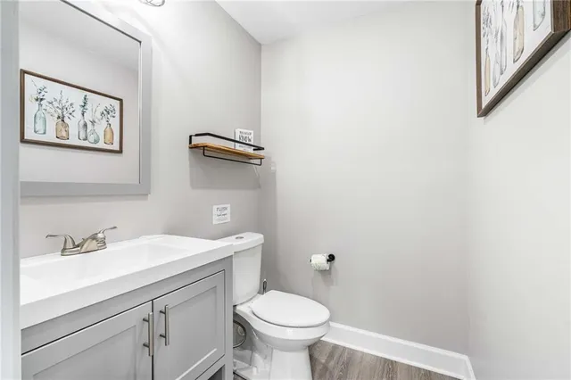 a bathroom with a toilet a sink and mirror