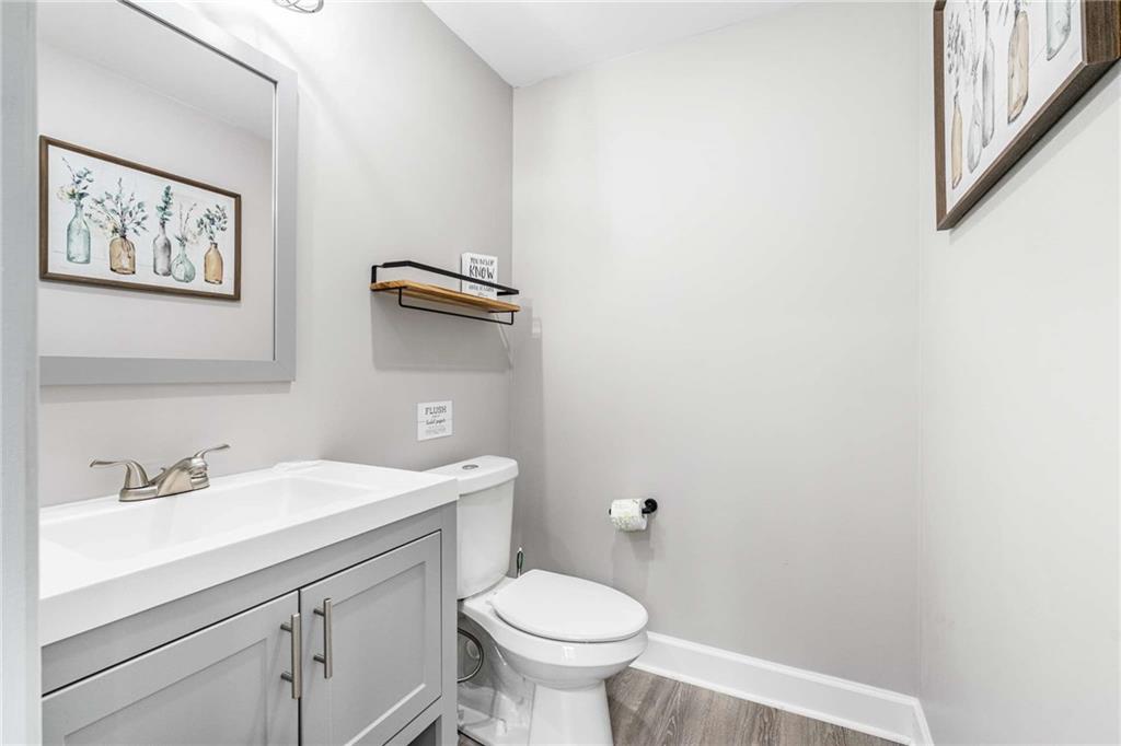 8393 Boardtown Road Ellijay, GA 30540 - Photo 12 of 54 a bathroom with a toilet a sink and mirror