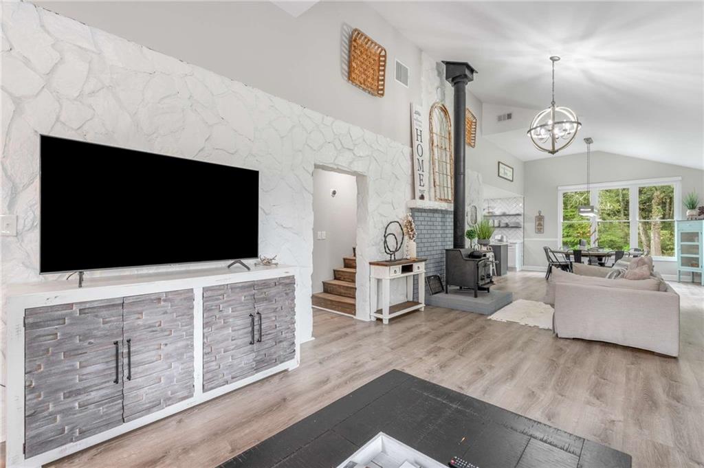 8393 Boardtown Road Ellijay, GA 30540 - Photo 15 of 54 a living room with furniture and a flat screen tv