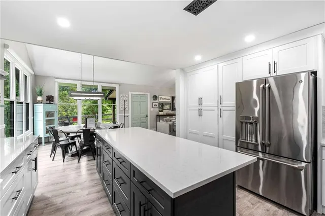 a kitchen with stainless steel appliances a stove a sink a refrigerator and cabinets
