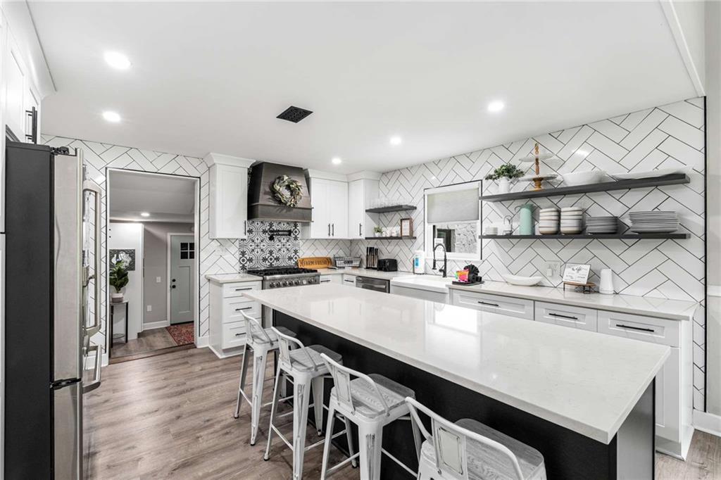 8393 Boardtown Road Ellijay, GA 30540 - Photo 21 of 54 a kitchen with stainless steel appliances a sink stove and refrigerator