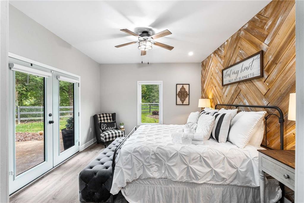 8393 Boardtown Road Ellijay, GA 30540 - Photo 24 of 54 a bedroom with a bed and a large window with the outer view