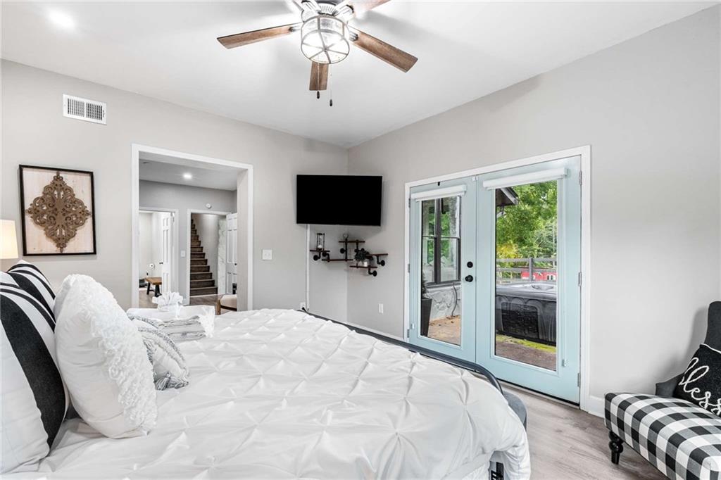 8393 Boardtown Road Ellijay, GA 30540 - Photo 25 of 54 a bedroom with a large bed and a flat screen tv