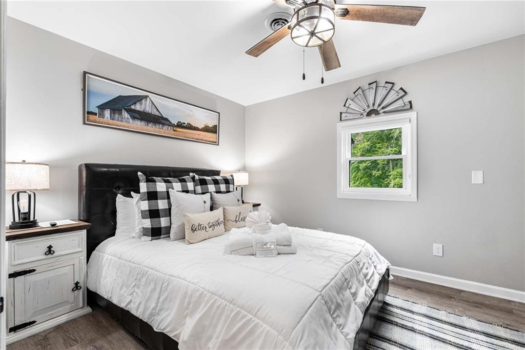 8393 Boardtown Road Ellijay, GA 30540 - Photo 28 of 54 a bedroom with a bed and a chandelier