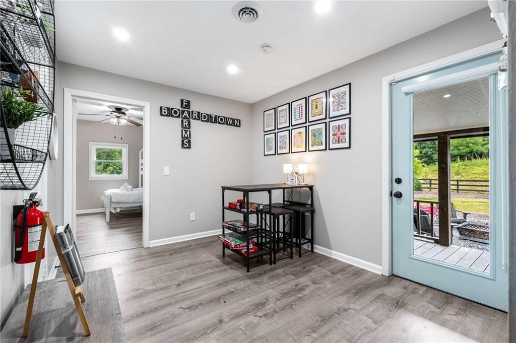 8393 Boardtown Road Ellijay, GA 30540 - Photo 30 of 54 a living room with furniture and a wooden floor