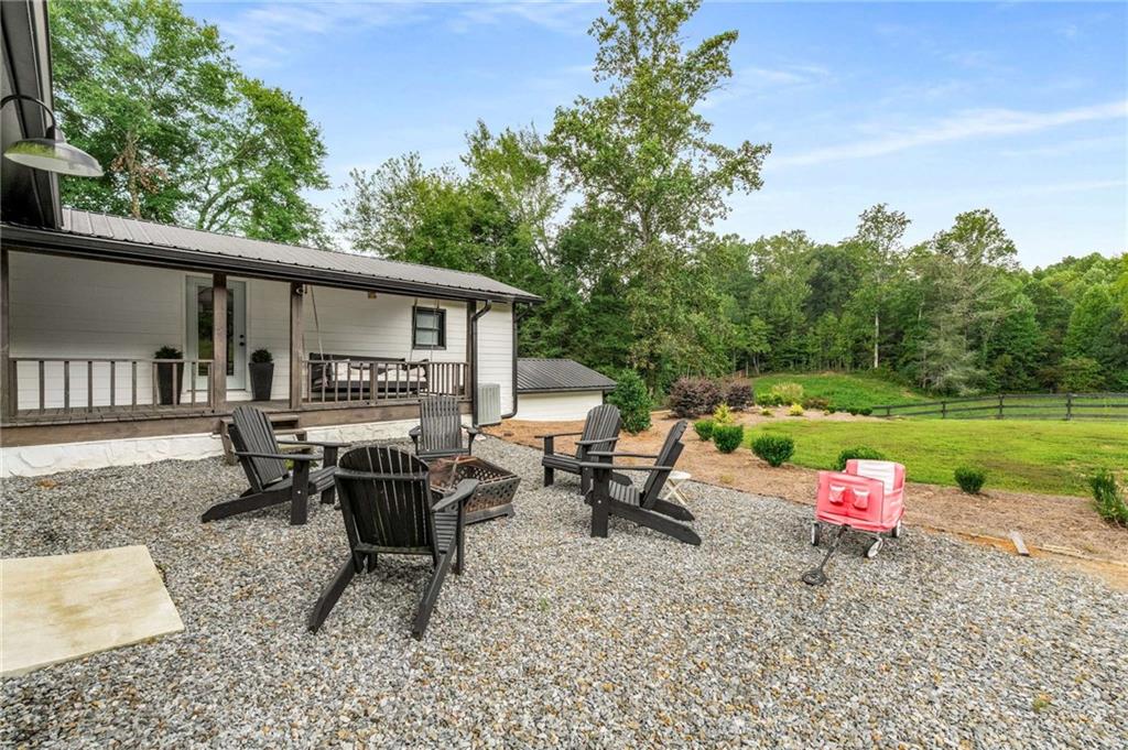 8393 Boardtown Road Ellijay, GA 30540 - Photo 33 of 54 an outdoor sitting area with furniture and garden