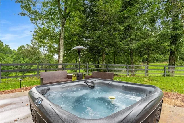 a view of a house with pool and a yard
