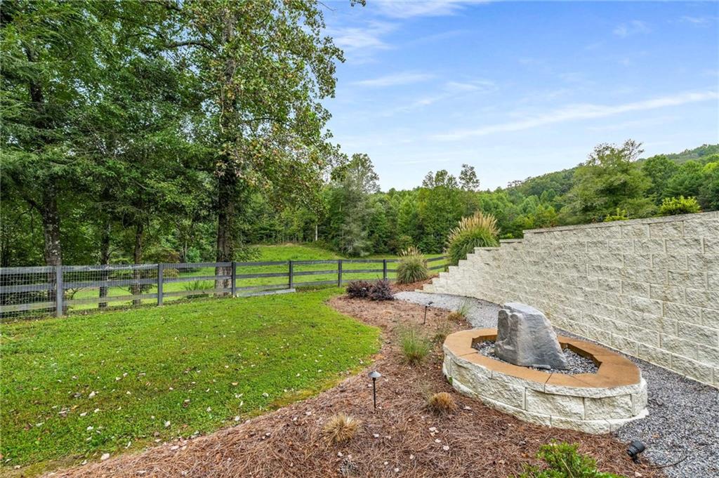 8393 Boardtown Road Ellijay, GA 30540 - Photo 37 of 54 a backyard of a house with table and chairs