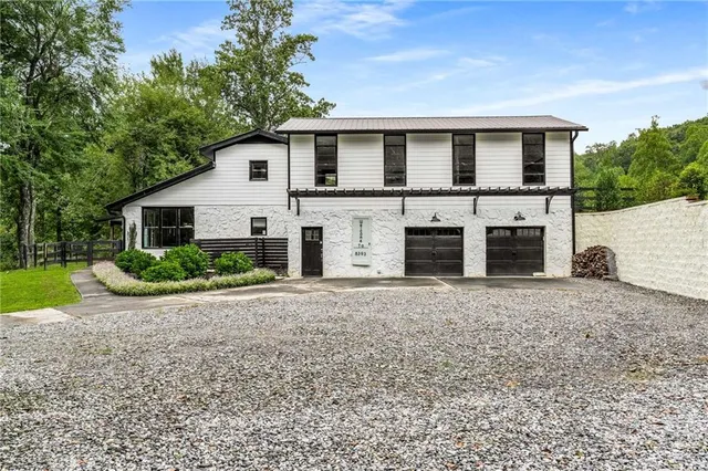 a backyard of a house with table and chairs