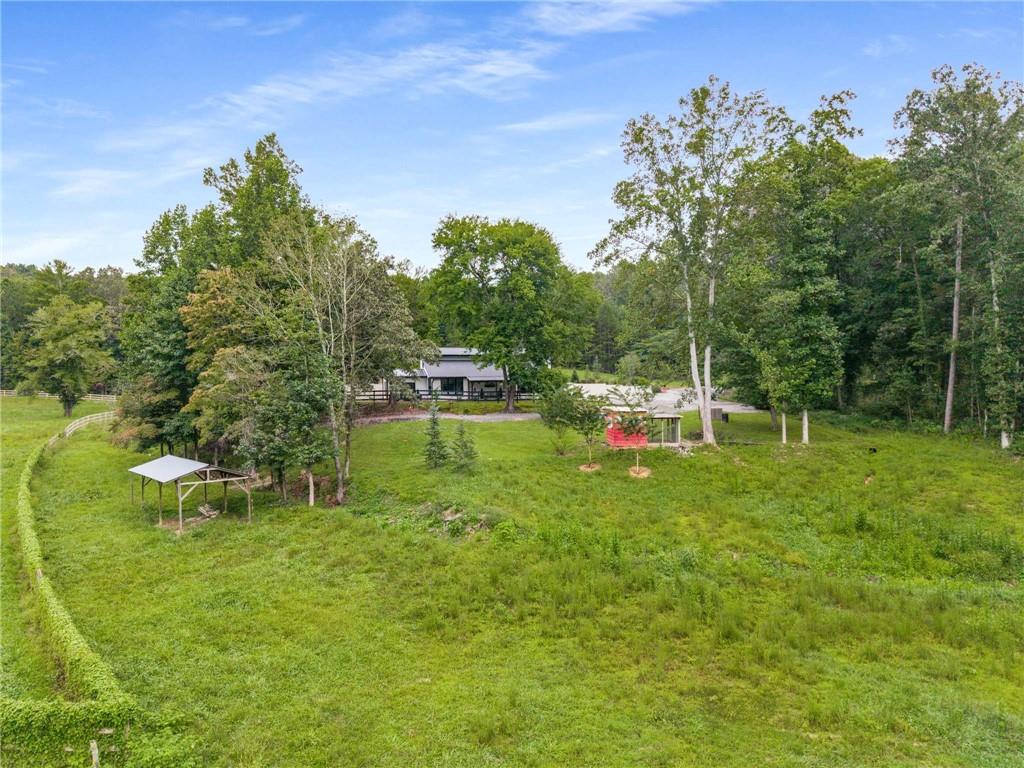 8393 Boardtown Road Ellijay, GA 30540 - Photo 44 of 54 a backyard of a house with table and chairs