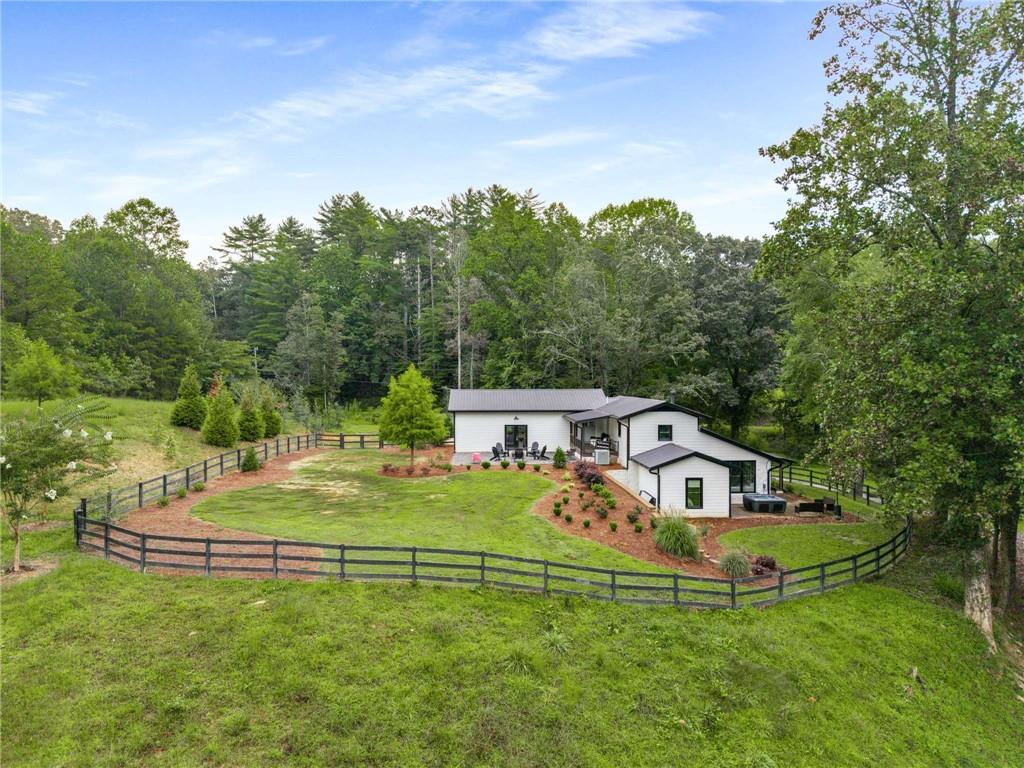 8393 Boardtown Road Ellijay, GA 30540 - Photo 46 of 54 a house with trees in the background