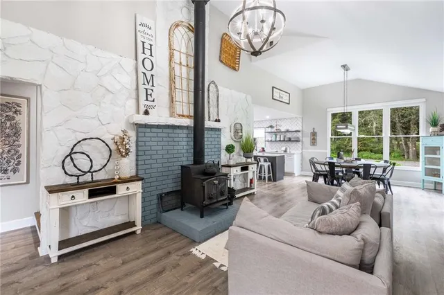 a living room with fireplace furniture and a large window