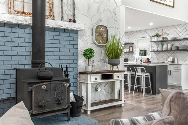 a kitchen with stainless steel appliances kitchen island granite countertop a stove a sink and a microwave