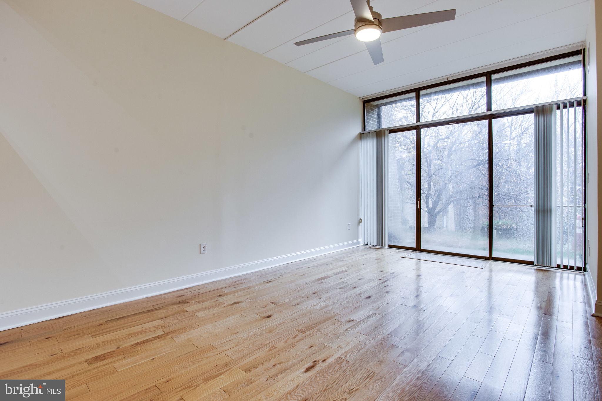 11556 Rolling Green Court, Unit 101 Reston, VA 20191 - Photo 7 of 30 Living Room with floor to ceiling glass wall