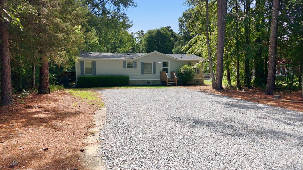 503 Whitten Road Waterloo, SC 29384 - Photo 1 of 31 a front view of a house with a yard and potted plants