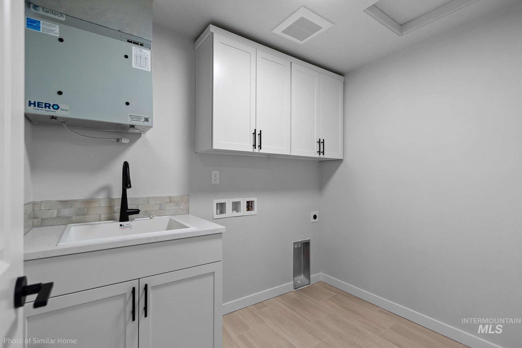 890 Adamite Road Kimberly, ID 83341 - Photo 15 of 16 Laundry room featuring cabinet space, hookup for a washing machine, electric dryer hookup, wood finish floors, and attic access