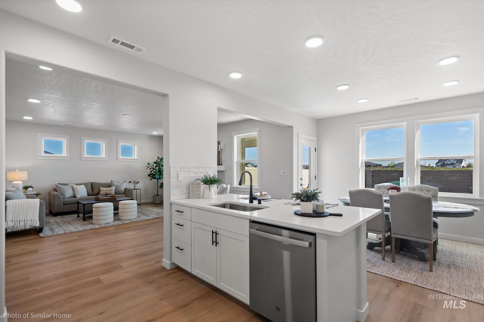 890 Adamite Road Kimberly, ID 83341 - Photo 16 of 16 Kitchen with white cabinetry, dishwasher, light wood finished floors, open floor plan, and recessed lighting