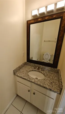 a bathroom with a granite countertop sink and mirror