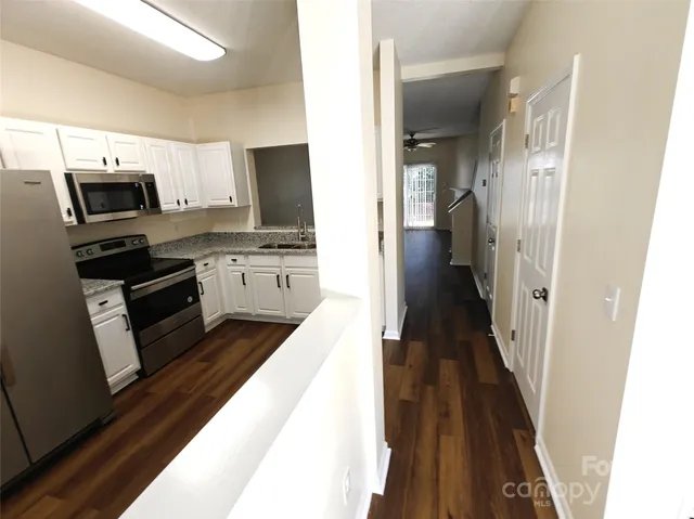 a view of kitchen with sink microwave refrigerator and stove
