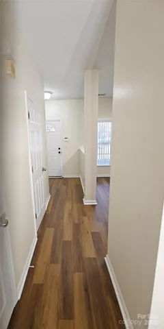 a view of a hallway view with wooden floor and staircase