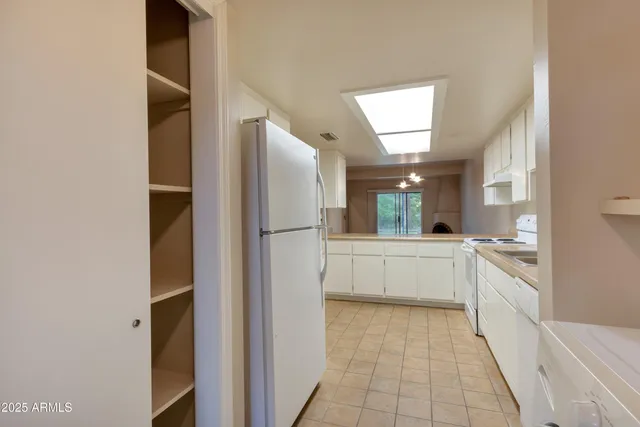 a kitchen with sink cabinets and window