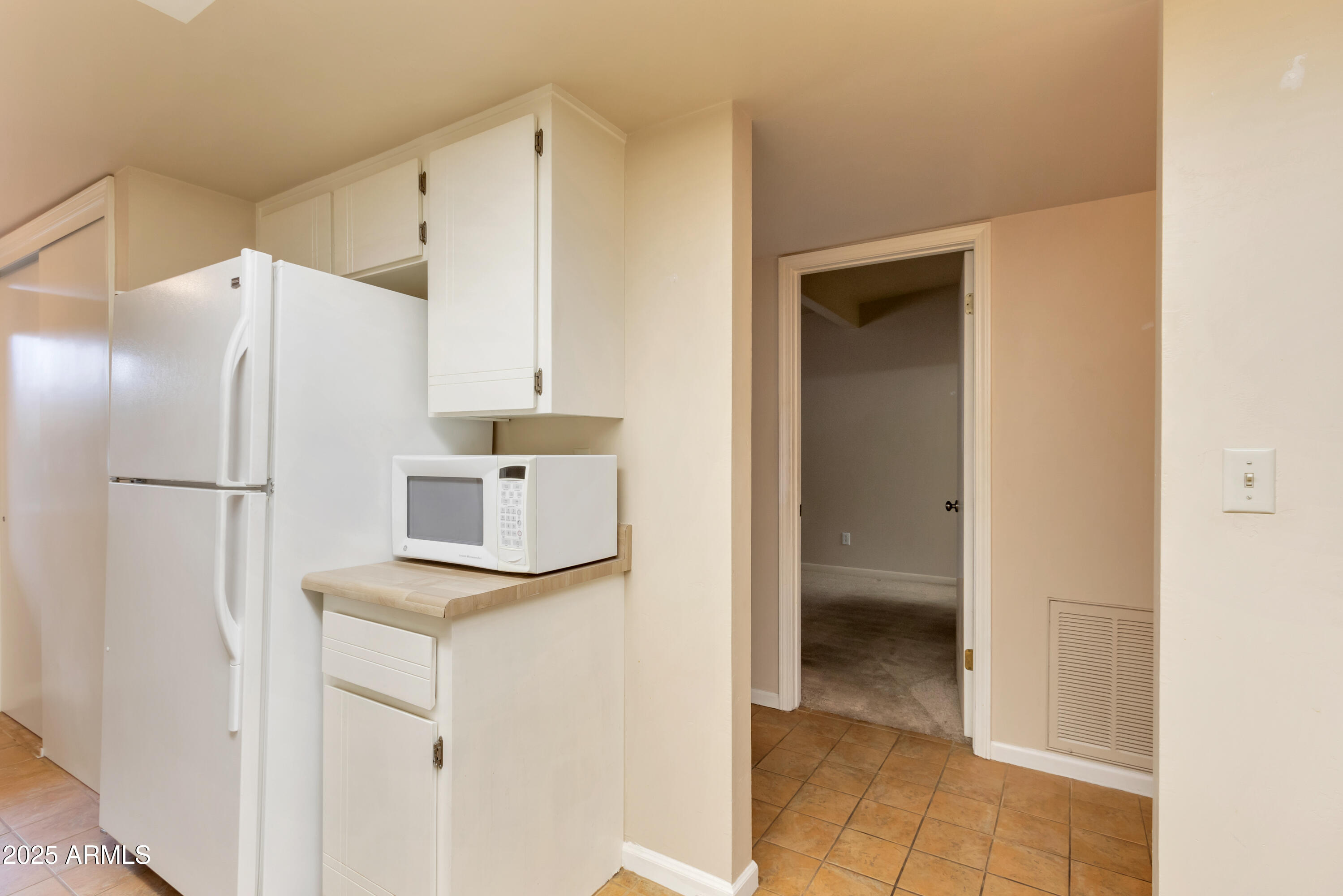 130 Castle Rock Road, Unit 45 Sedona, AZ 86351 - Photo 15 of 38 a kitchen with white cabinets and refrigerator