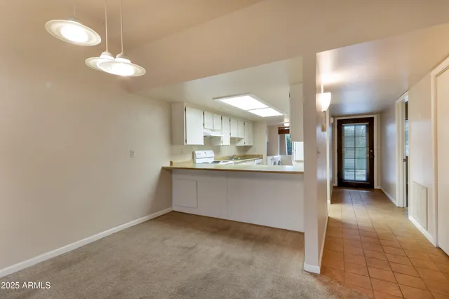 a view of a kitchen with a sink and a refrigerator