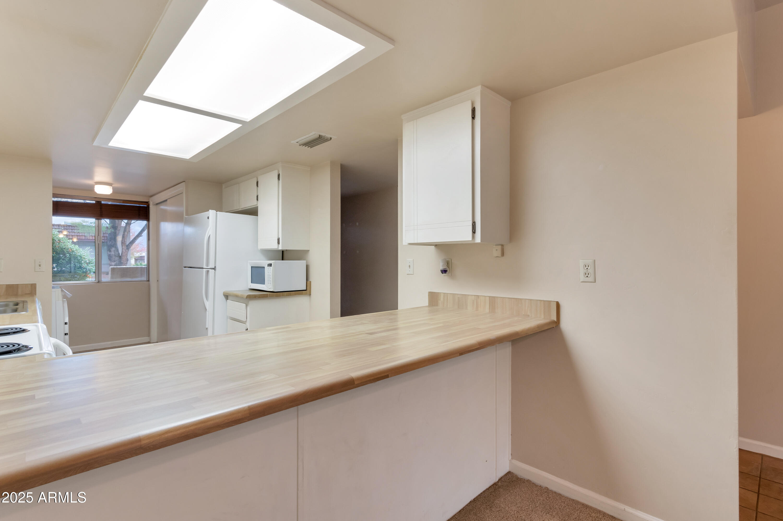 130 Castle Rock Road, Unit 45 Sedona, AZ 86351 - Photo 18 of 38 a view of a kitchen with a sink and a refrigerator