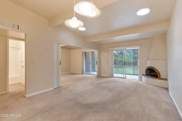 a view of a livingroom with wooden floor and a window