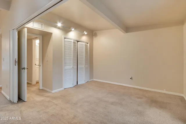 a view of a room with a wooden door