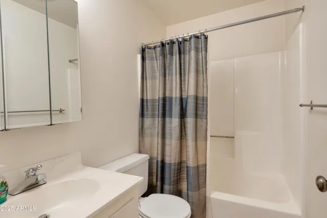 an empty room with windows and bathroom view