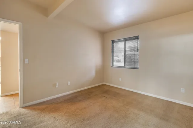 a view of an empty room and windows