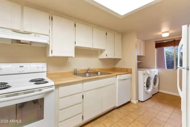 a kitchen with a refrigerator and window
