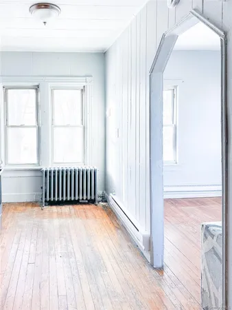 a view of a room with wooden floor and windows