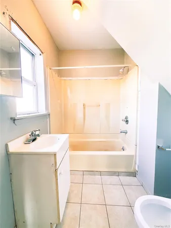 a bathroom with a sink a toilet and bathtub