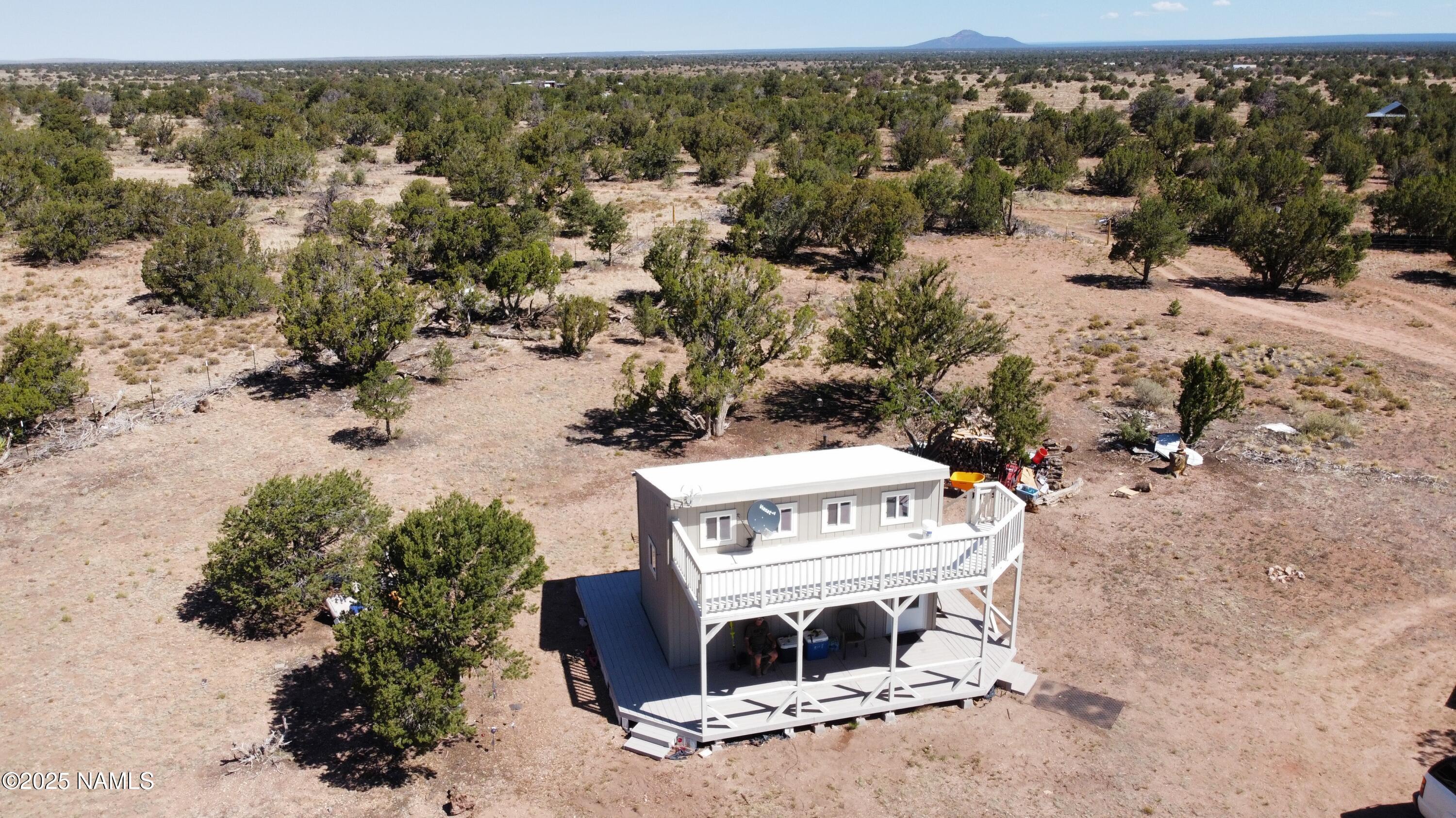 an aerial view of a house with yard