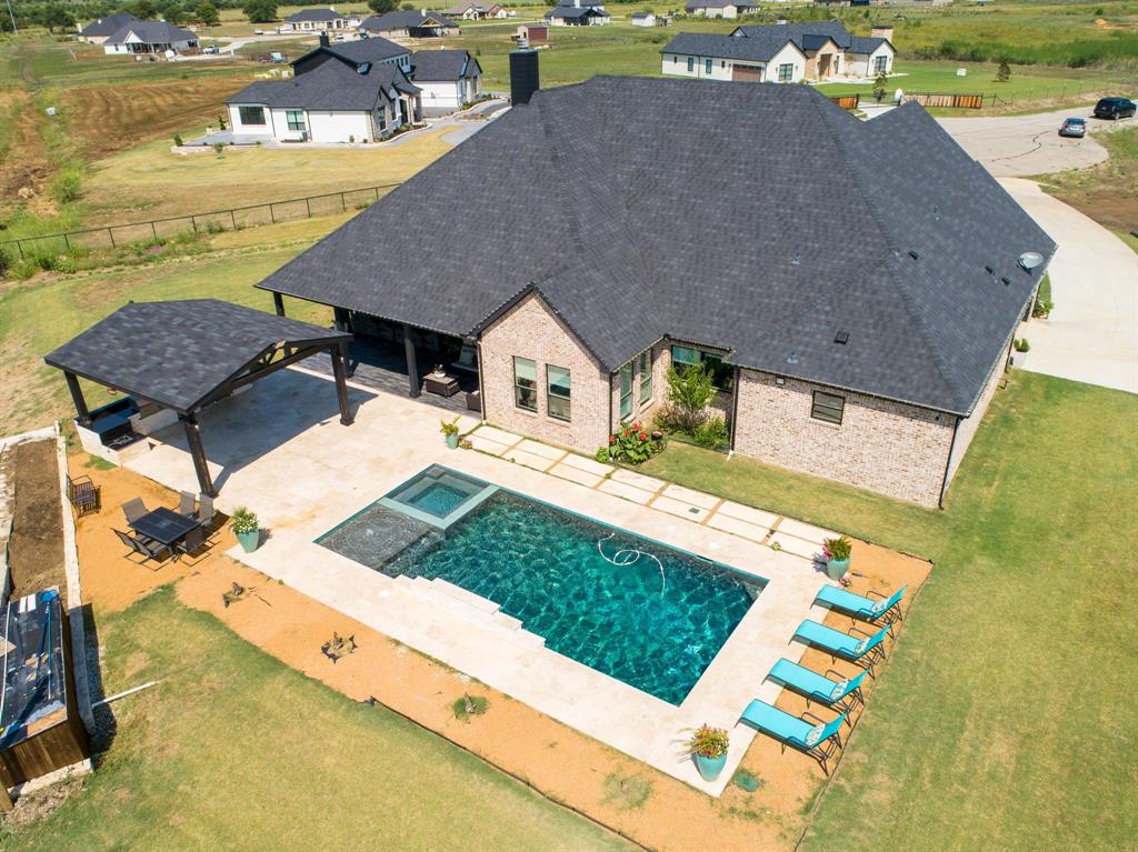 an aerial view of a house with outdoor space
