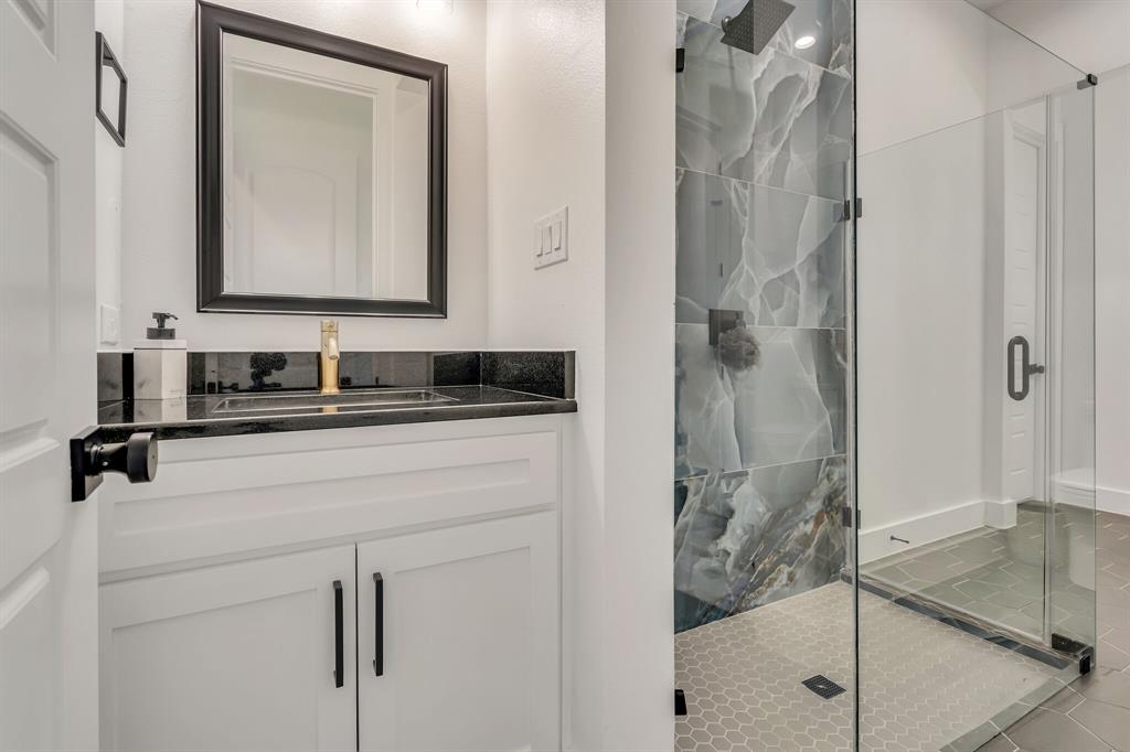 7299 Tom Trail Krum, TX 76249 - Photo 13 of 34 a bathroom with a mirror sink and vanity