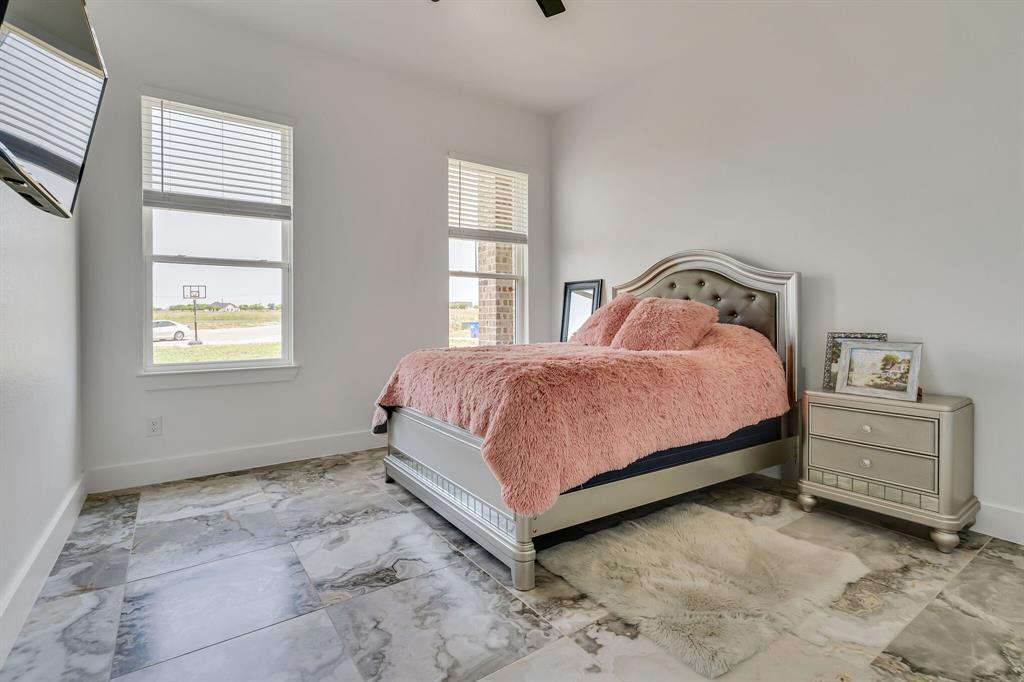 7299 Tom Trail Krum, TX 76249 - Photo 16 of 34 a bedroom with a bed and a window