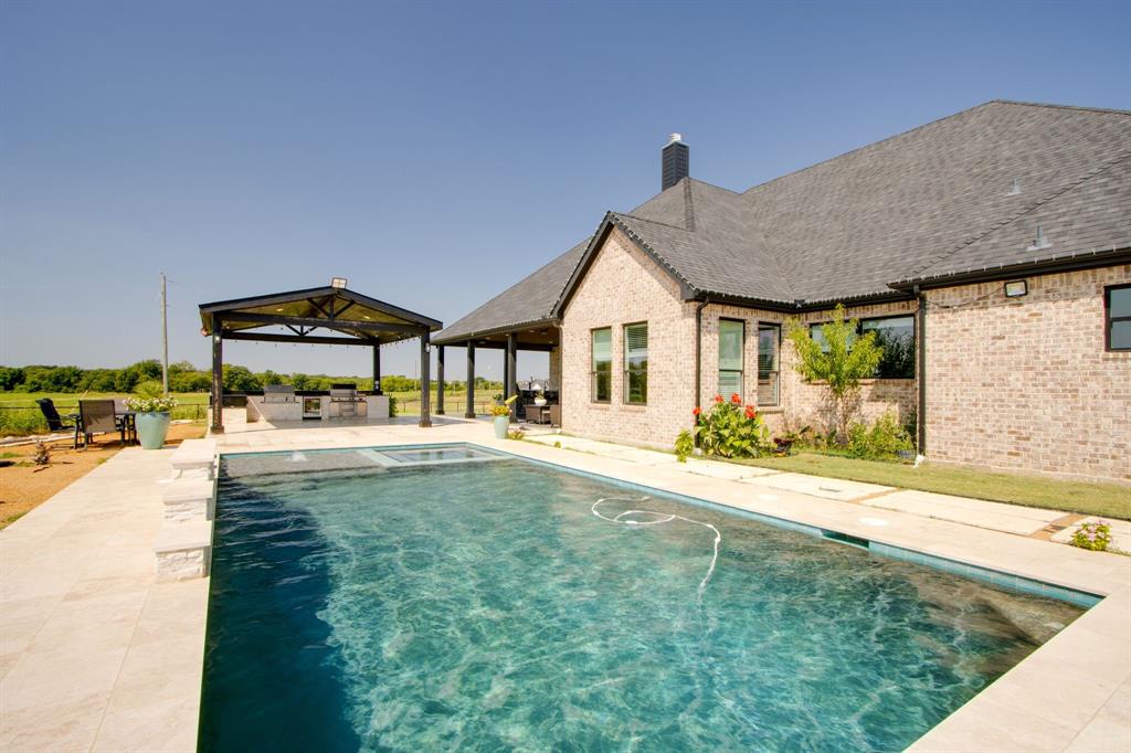 7299 Tom Trail Krum, TX 76249 - Photo 27 of 34 a house with swimming pool in front of it