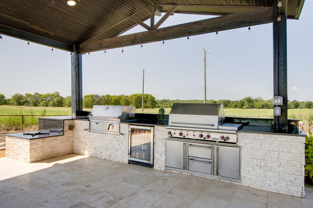 7299 Tom Trail Krum, TX 76249 - Photo 28 of 34 a open kitchen with stainless steel appliances granite countertop a stove and a refrigerator