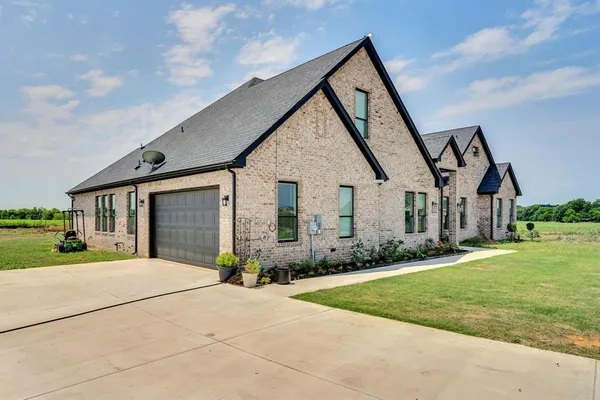 a front view of house with yard and green space