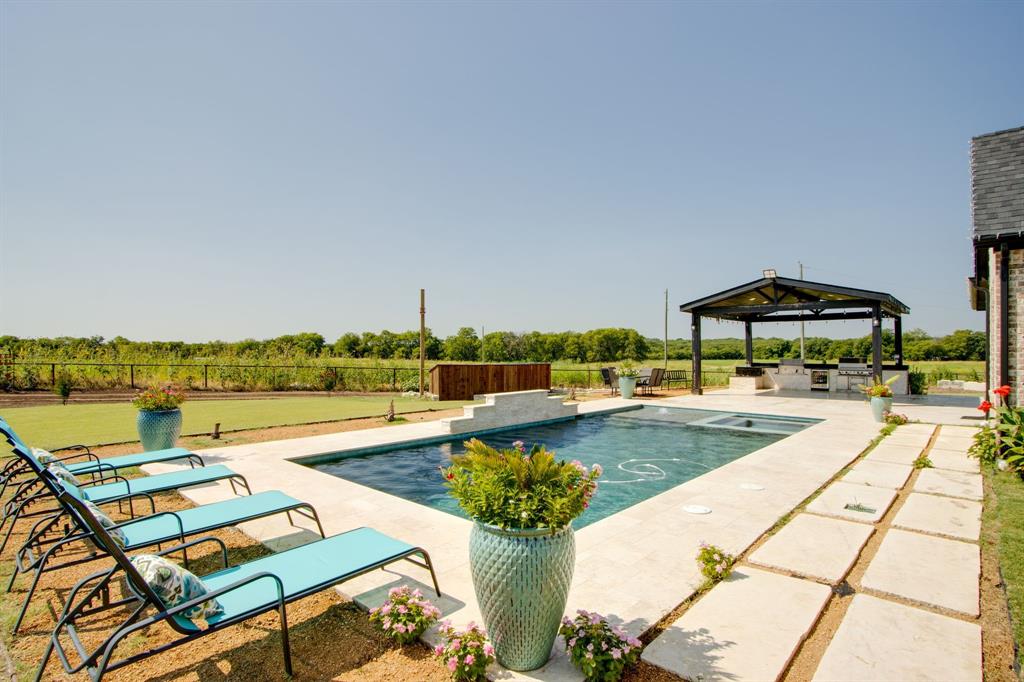 7299 Tom Trail Krum, TX 76249 - Photo 31 of 34 a view of swimming pool with outdoor seating and lake view